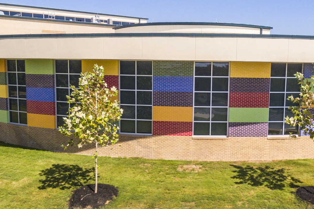 The colorful library addition projects its presence as a beacon to the community.