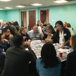 Members of Alamo Architects (Principal Nicki Marrone, standing) leading a workshop and gathering responses from participants.