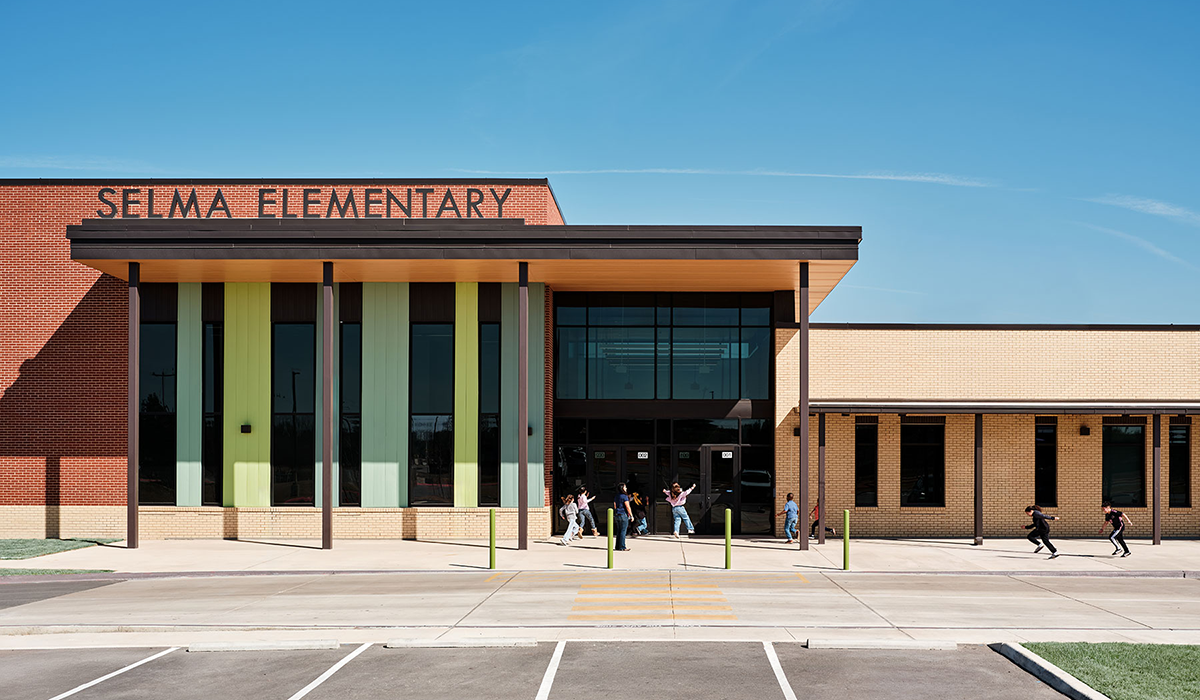 Car Drop-off and Secure Entry | A welcoming front door greets arriving students each morning at drop-off, and the Secure Entry is framed with graphics featuring local Cibolo Creek Natural Area. The elevation recapitulates the theme of tradition contrasted with innovation.