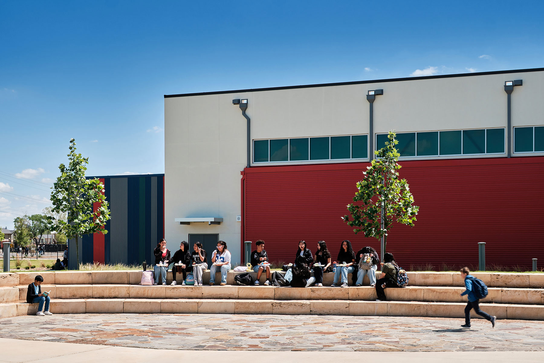 Students convene at the outdoor amphitheater, a phase II feature, which sits in front of the high school gym, from phase III.